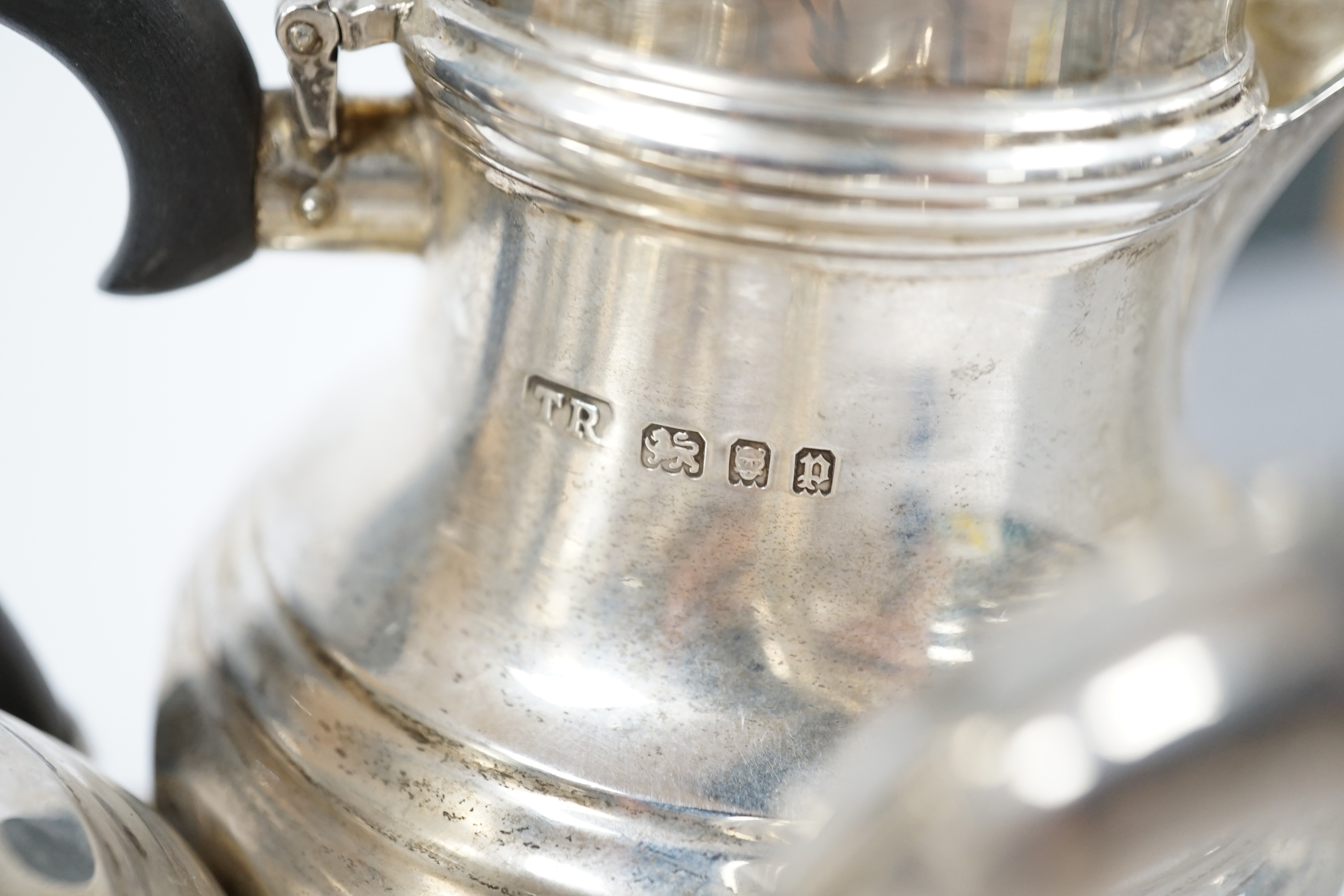 A George V silver bachelors pear shaped café au lait pair, by Theodore Rossi, London, 1930 and an earlier silver tea caddy, gross weight 18.5oz. Condition - poor to fair